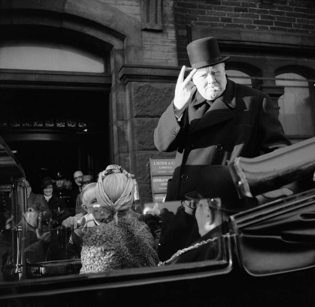 winston-churchill-cigar-in-mouth-gives-his-famous-v-for-victory-sign-during-e679c3 (1)
